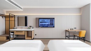 A modern hotel room with two beds, a desk, a chair, a TV mounted on the wall, and a wooden cabinet. - HomeInn Plus Guozhan Liufang Subway Stn (Beijing)