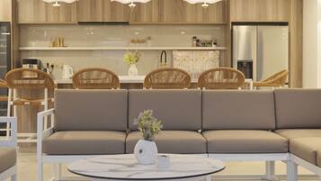 A modern kitchen with wooden cabinets, a built-in oven, and a stainless steel refrigerator.