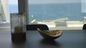 A table with a glass vase and a wooden bowl.