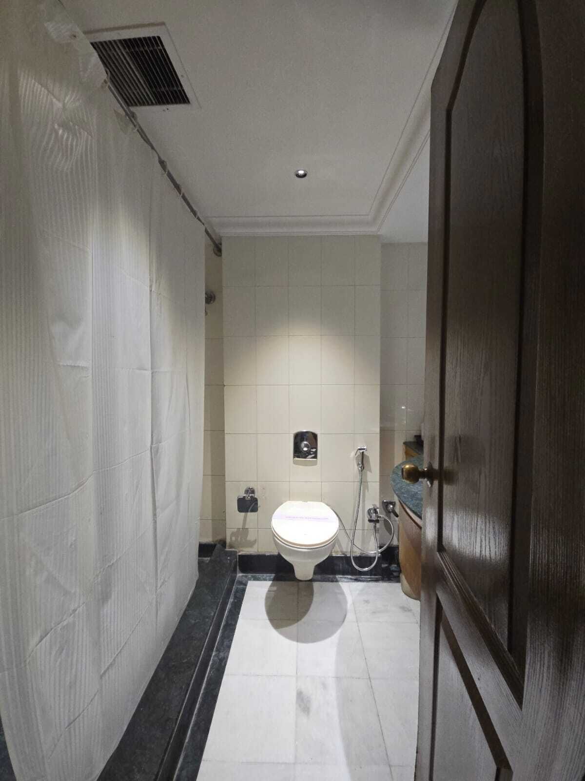 A bathroom with a toilet, bidet, and a shower.