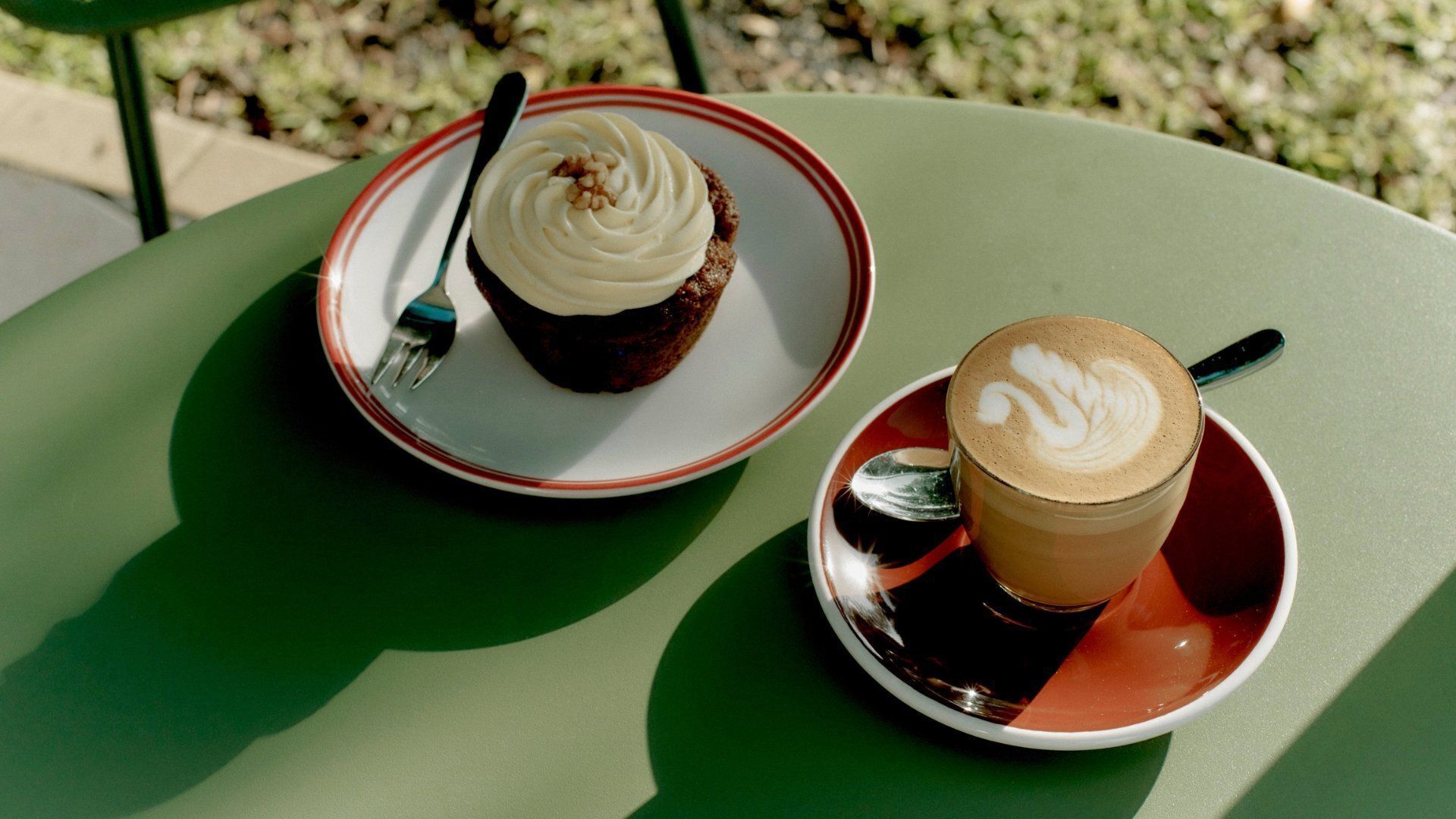 A table with a plate of food and a cup of coffee.