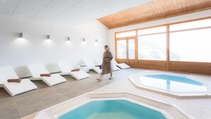 A spa area with sun loungers and a large window providing a view of the outdoors. - Apartment in Sainte-Foy with Ski-In/Ski-Out (Sainte-Foy Tarentaise)
