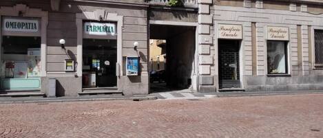 A building with storefronts labeled "OMEOPATIA" and "FARMACIA."