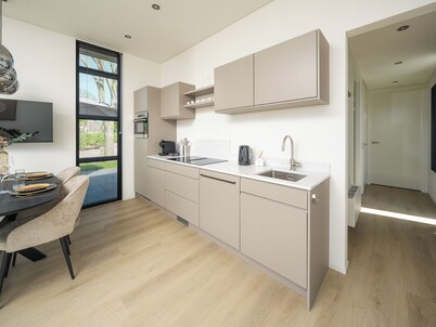 Enjoy a luxurious 4-person villa near the water, with two bedrooms, two bathrooms and a sunny garden with lounge set.