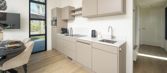Enjoy a luxurious 4-person villa near the water, with two bedrooms, two bathrooms and a sunny garden with lounge set.