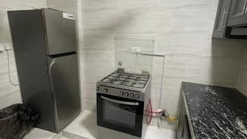 Full-sized fridge, oven, stovetop, cookware/dishes/utensils
