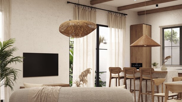 Una sala moderna con un gran sillón de peluche redondo, una zona de comedor con sillas de madera, un televisor montado en la pared y un ventanal con cortinas.