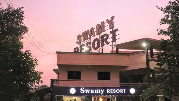 Swamy Resort with a prominent sign, a covered entrance, and potted plants outside. - SWAMY RESORT (Shirdi)