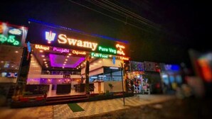 A restaurant named Swamy with signs for Punjabi, Chinese, and Pure Veg cuisine. - SWAMY RESORT (Shirdi)