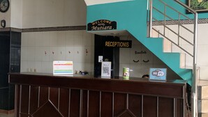 A reception desk with a sign reading "Welcome Hotel Mutiyana" and a "Free WiFi Zone" sign. - Hotel O Depok near Bhayangkara BRIMOB Hospital Formerly Hotel Mutiara Kelapa Dua Depok (Depok)