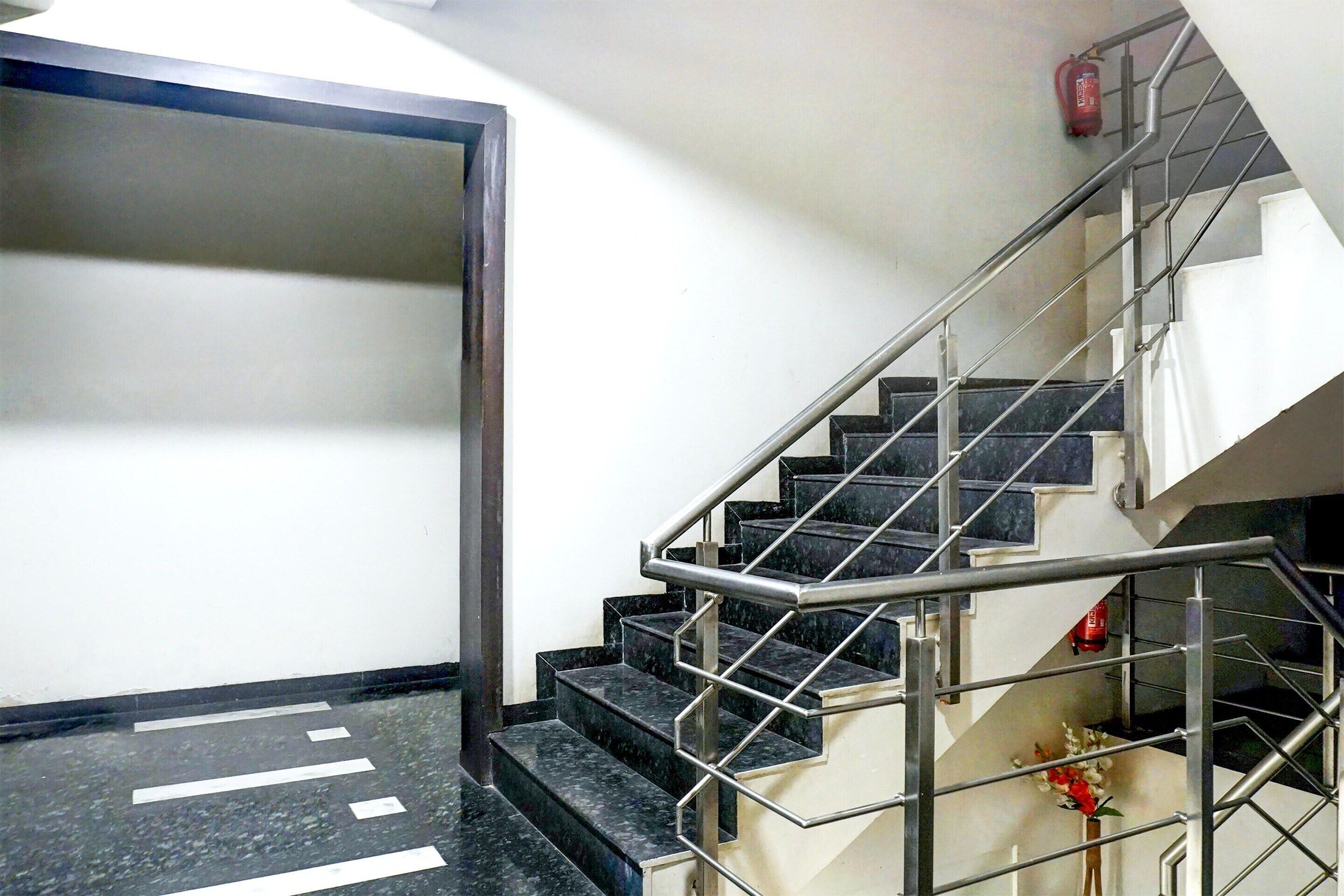 A staircase with metal railings and black marble steps.