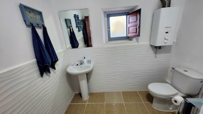 A small bathroom with a sink, toilet, and a window. - Casita-1 To 2guests-pool-patio-bbq-parking (Huercal-Overa)