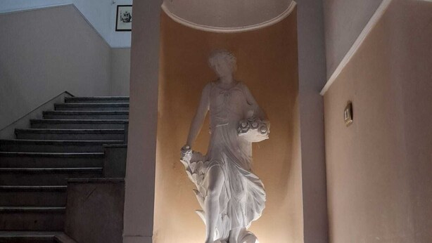 A staircase with a statue in the center.