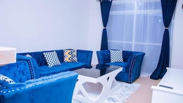 Comfort Apartment, City View | Living area | 32-inch Smart TV with digital channels