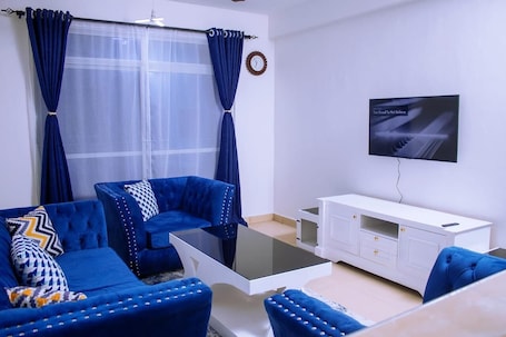 Comfort Apartment, City View | Living area | 32-inch Smart TV with digital channels