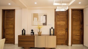 A modern interior with wooden doors, a central console, and a minimalist decor. - little hideaway (Dar es Salaam)