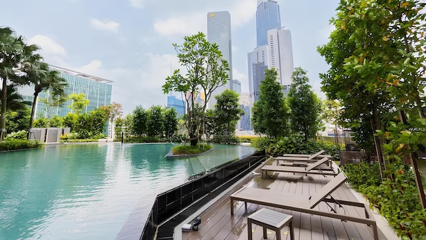 A serene rooftop pool area with a view of modern skyscrapers in the background. - Agile Residence Dual-Key Gem @ Bukit Bintang F11 By Natol (Kuala Lumpur)