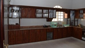 Eine Küche mit Holzausstattung, einem Spülbecken und einem Fenster für natürliches Licht.