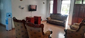 Family Apartment, City View | Living area | 32-inch Smart TV with digital channels