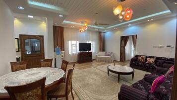Family Chalet, 4 Bedrooms, Patio, Poolside | Living area | 32-inch Smart TV with satellite channels