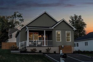 A two-story building with a porch, large windows, and a garage. - The Jolly Rancher (Hummelstown)