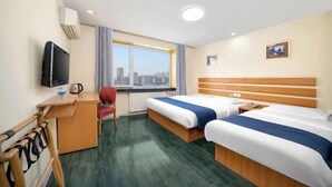 A hotel room with two beds, a desk, a chair, a television, and a window with a city view. - Harbin Dashu Hotel (Harbin)