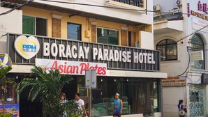 The exterior of Boracay Paradise Hotel with a sign for Asian Plates. - Boracay Paradise Hotel (Boracay Island)