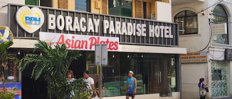 The exterior of Boracay Paradise Hotel with a sign for Asian Plates.