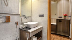 A modern bathroom with a large mirror, a white sink, and a wooden vanity. - Vinsober Kainchi Dham Nainital  (Kosiyakutoli)