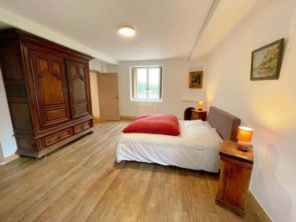 A bedroom with a bed, wooden wardrobe, a window, and a nightstand with a lamp. - The Ronsard Mill: Spacious house, garden, and Loir view - 8 people (Vallée-de-Ronsard)