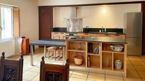 Une cuisine moderne dotée d’un îlot central, d’un four encastré et d’appareils électroménagers en acier inoxydable.