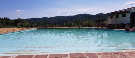 A swimming pool with a clear view of mountains in the background.