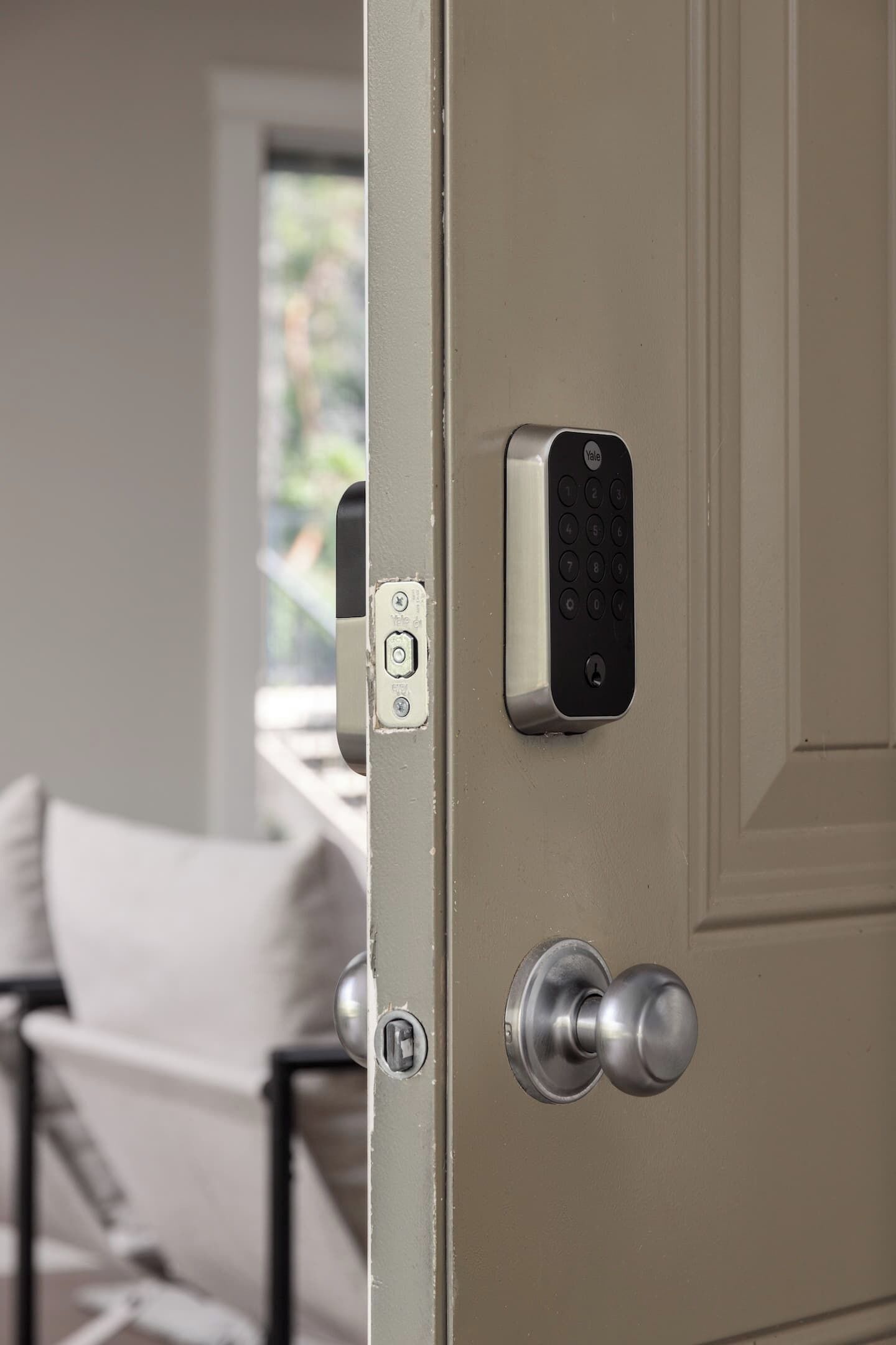 A door with a keypad lock and a keyhole.