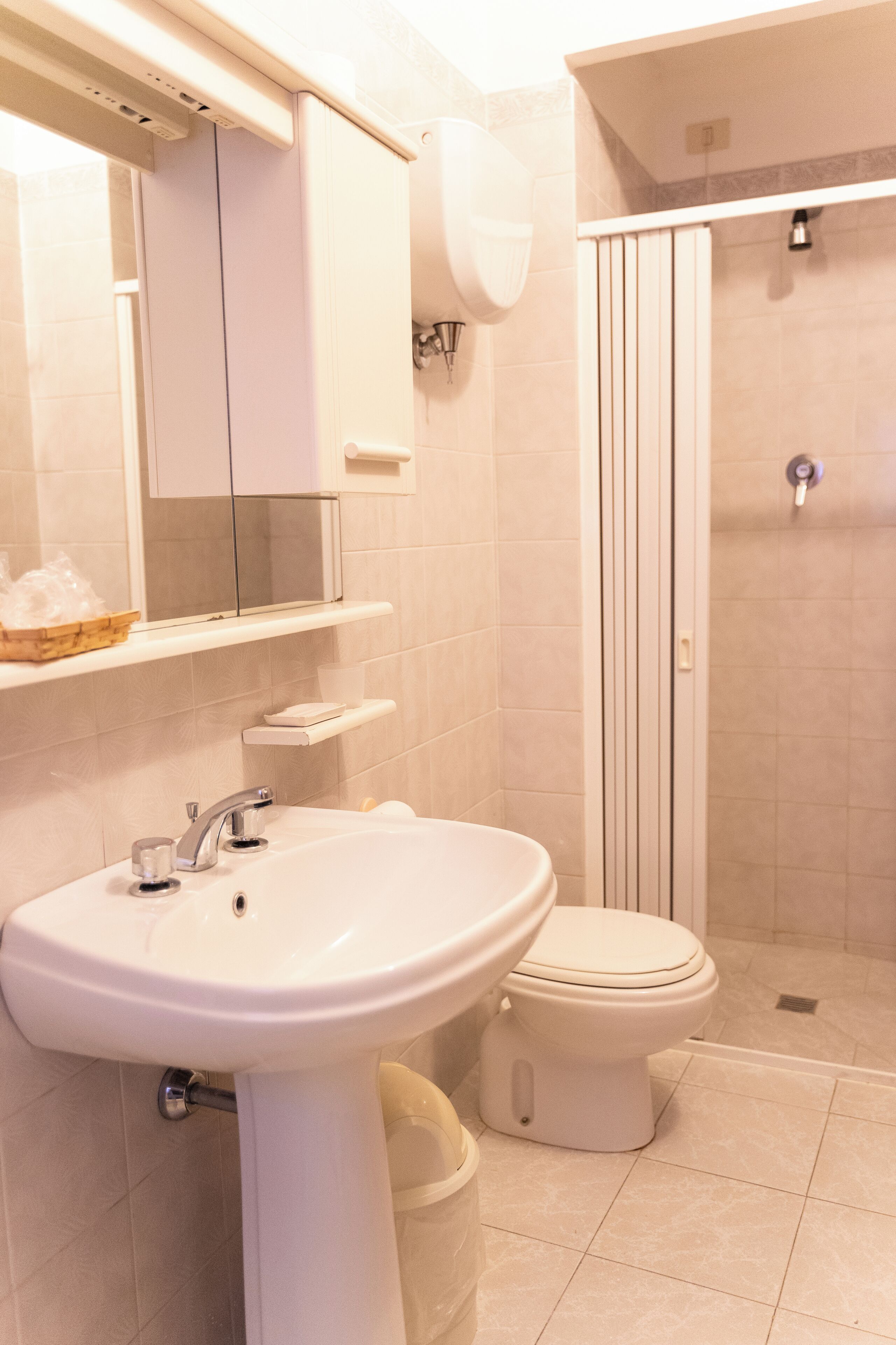 A bathroom with a sink, toilet, and shower.