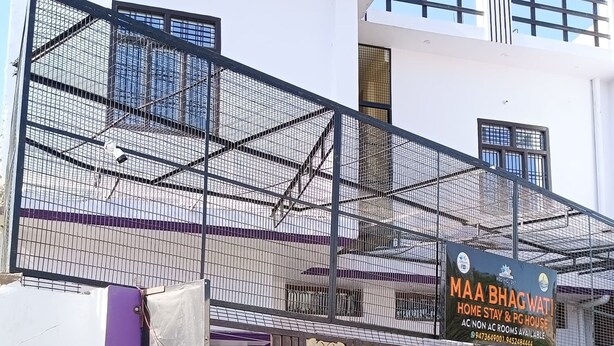 A two-story building with a sign advertising "Maa Bhagwat Home Stay & PG House" with contact information. - Maa Bhagwati Home Stay (Faizabad)