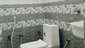 A bathroom with a toilet, a shower, and a sink. - Maa Bhagwati Home Stay (Faizabad)