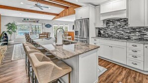A spacious kitchen with white cabinets, a stainless steel refrigerator, and a tiled backsplash. - 3 Bedrooms, 1 Flex Rooms, 3 Bathrooms!  Lakefront Home with SUNSET VIEWS, located near Hales Ford Br (Moneta)