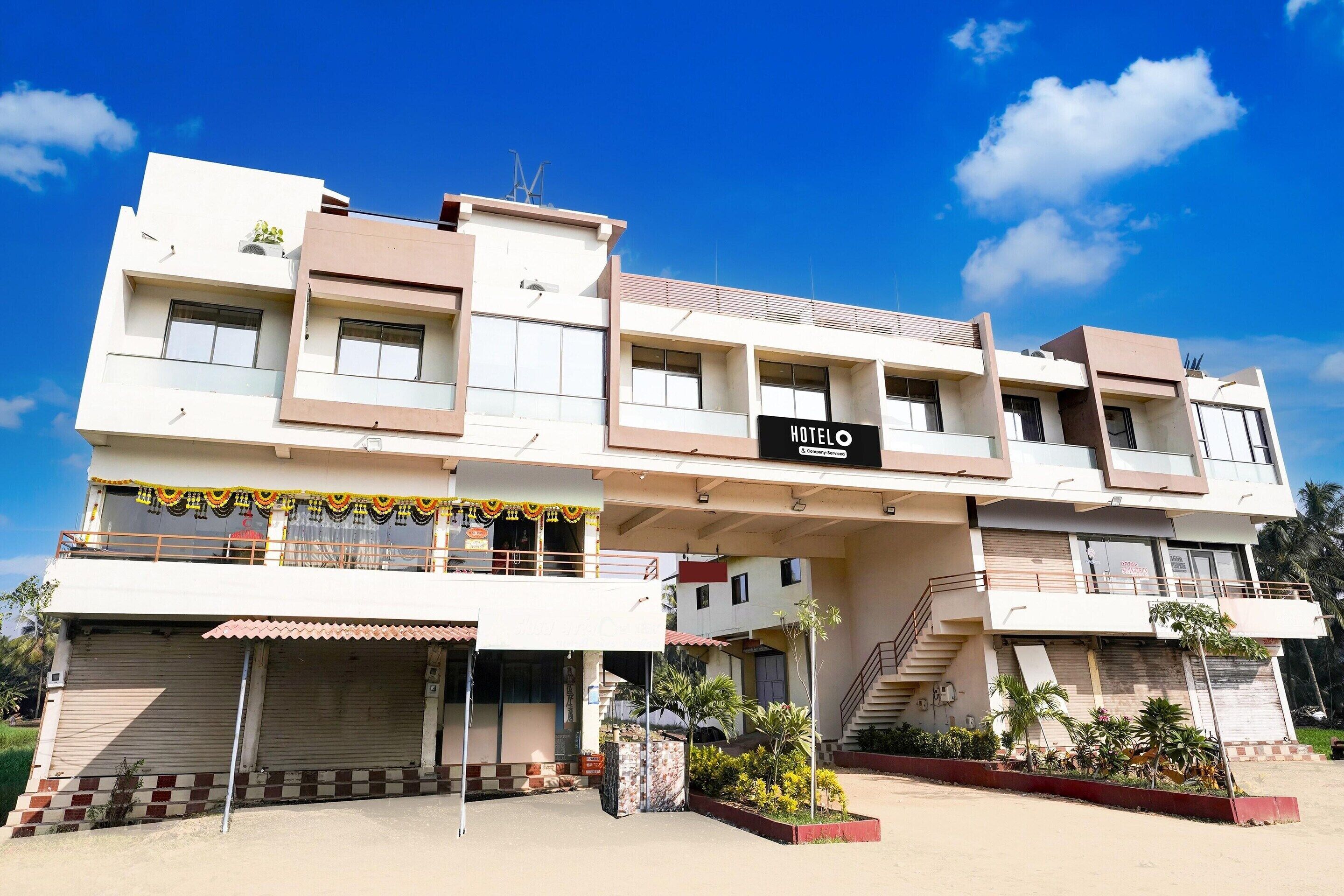 A multi-story hotel with a flat facade, balconies, and a sign indicating it is a hotel.