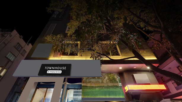 A building with a sign reading "TOWNHOUSE" and "Company Serviced." - Classic Q Rooms BTM Gopalan Ovation Mall (Bengaluru)
