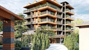 A multi-story hotel with balconies, a central courtyard, and surrounding greenery. - Sunday Hotel Dharamshala (Dharamshala)