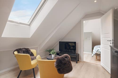 Standard Apartment | Living area | 50-inch flat-screen TV with cable channels
