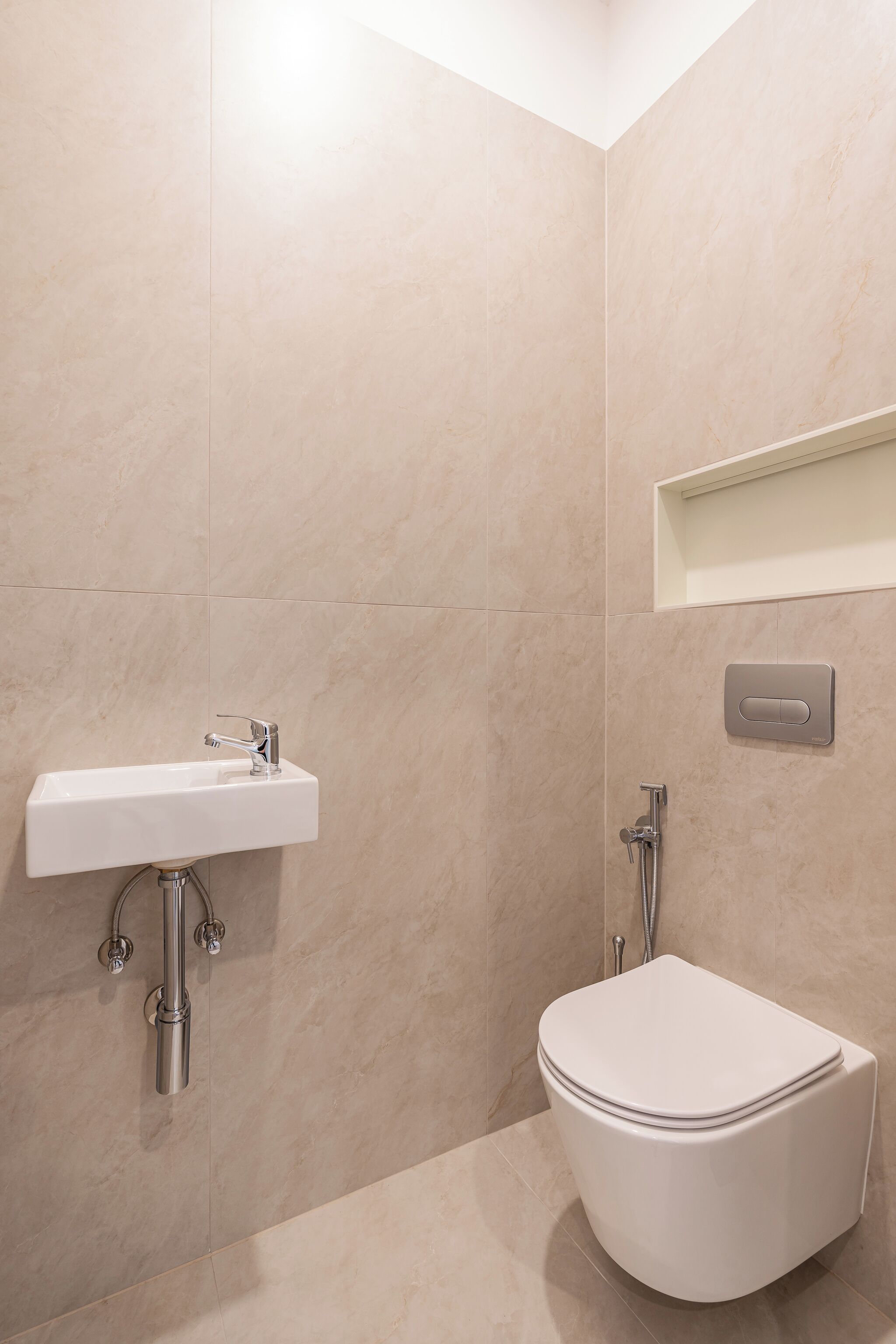 A modern bathroom with a white sink, a toilet, and a shower.