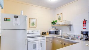 A modern kitchen with a refrigerator, stove, microwave, and sink. - Dock & Fire Pit: Scenic Studio on Suwannee River! (Chiefland)