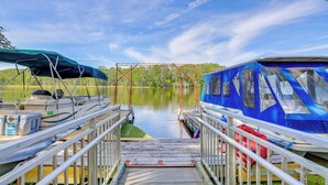 A dock with boats, a wooden walkway, and a clear sky. - Dock & Fire Pit: Scenic Studio on Suwannee River! (Chiefland)