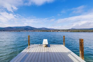 A wooden dock extending into a calm lake with mountains in the background. - Private Dock at Lake George Getaway (Lake George)