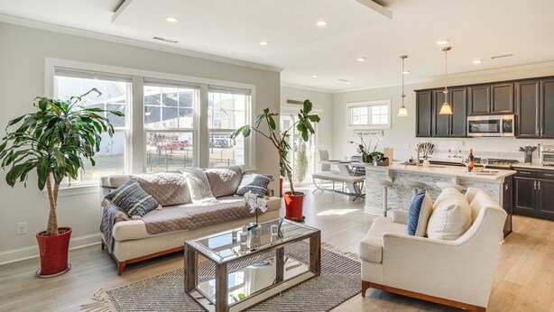 A modern living room with a sofa, coffee table, and potted plants. - 3 Mi to Umstead State Park: Durham Home (Durham)