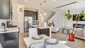 A modern kitchen with a central island, stainless steel appliances, and pendant lighting. - 3 Mi to Umstead State Park: Durham Home (Durham)