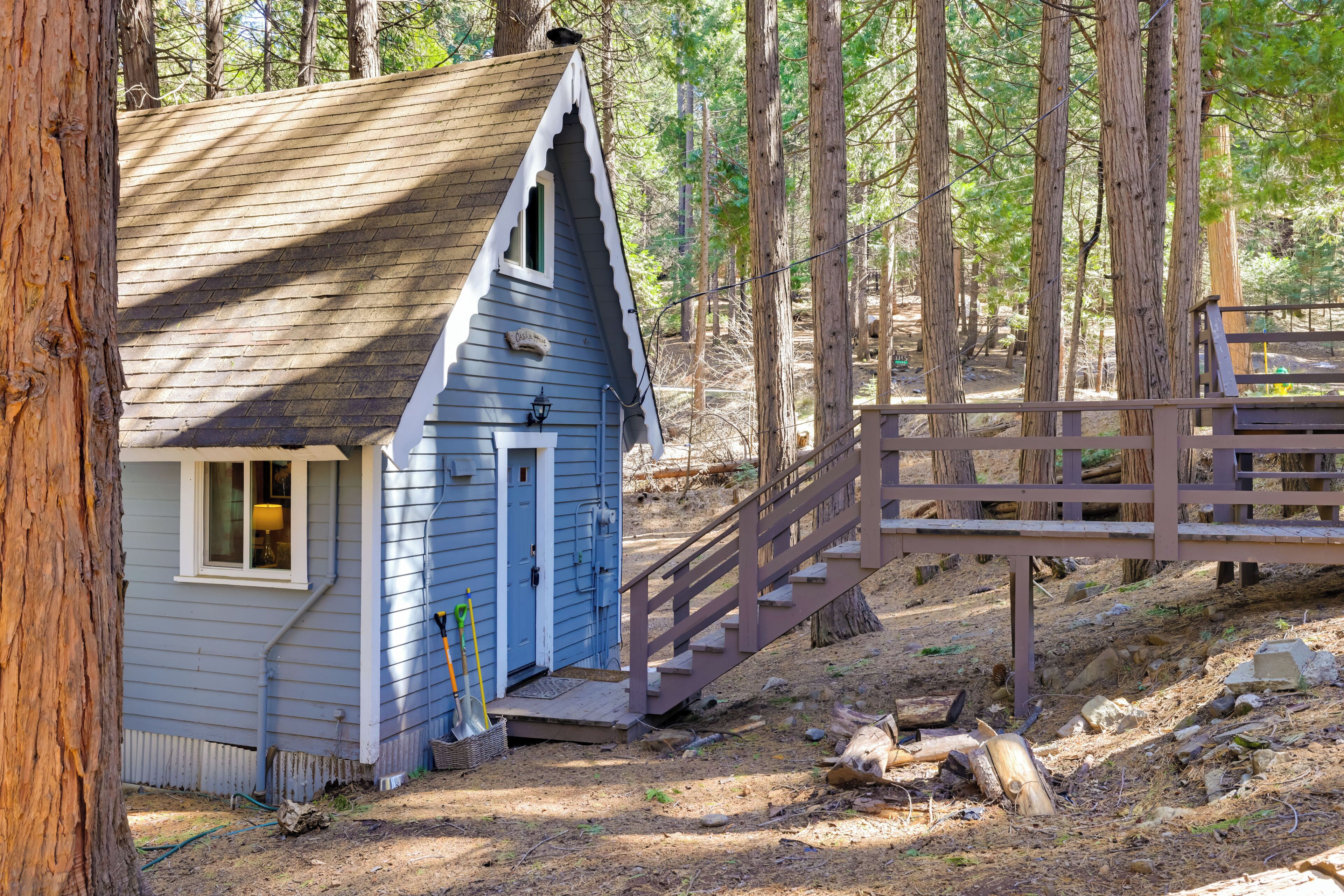A small cabin with a wooden staircase leading up to a porch.