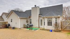 A residential backyard with a barbecue setup, a wooden fence, and a clear sky. - 2 Mi to Heritage Park: Pet-friendly Mcdonough Home (McDonough)
