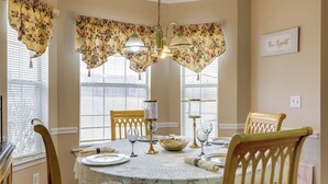 A dining room with a round table set for four, surrounded by wooden chairs. - 2 Mi to Heritage Park: Pet-friendly Mcdonough Home (McDonough)